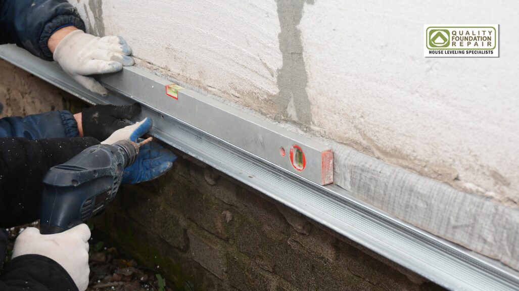 Quality Foundation Repair Austin checking a stem wall for level during a foundation repair.