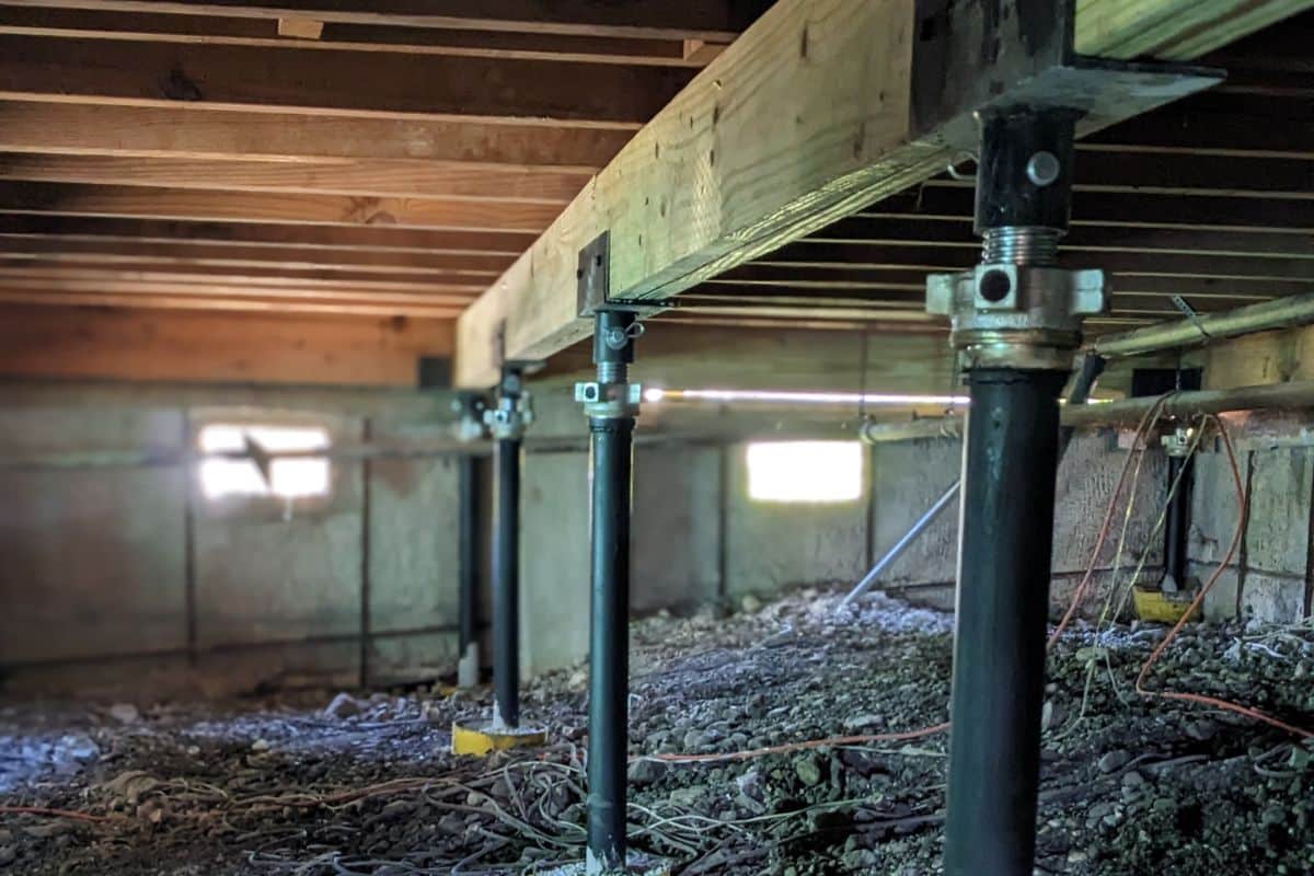 Quality Foundation Repair Austin Adjust-A-Piers supporting floor beams across a crawl space.