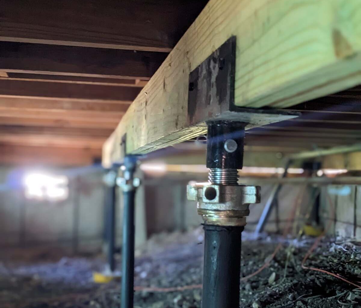 Quality Foundation Repair Austin Adjust-A-Pier supporting a floor beam in a Central Texas crawl space.