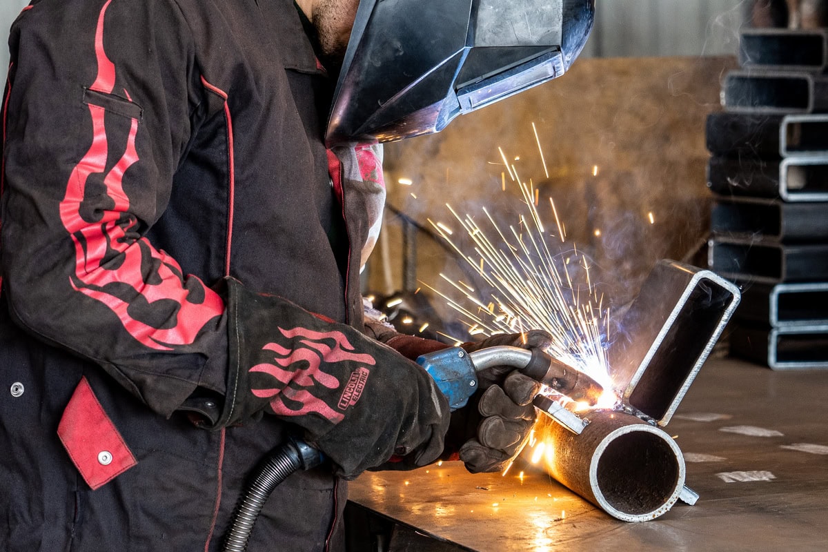 Quality Foundation Repair Austin welding a steel pier section in the company workshop.