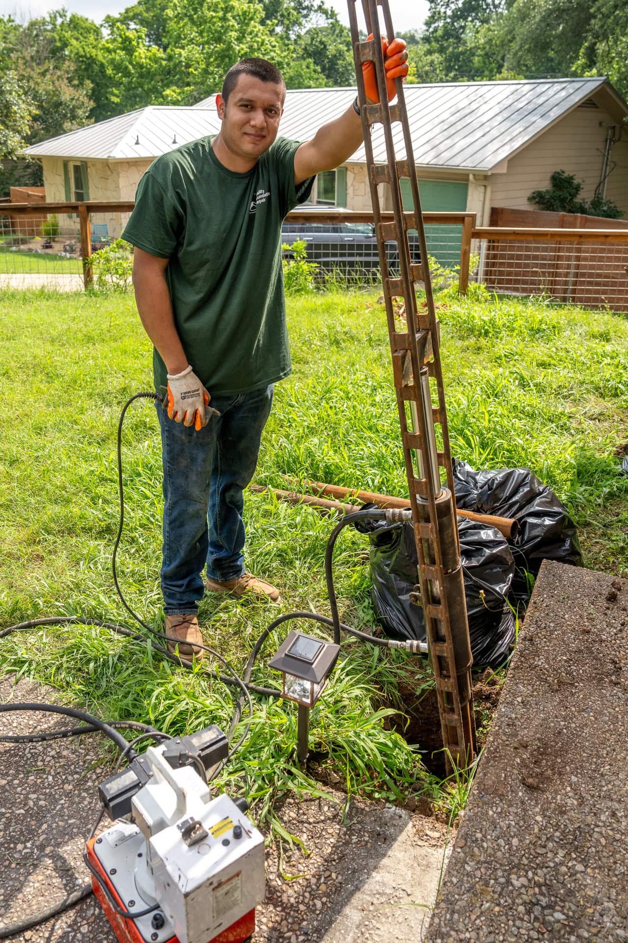 Quality Foundation Repair Austin technician installing push piers for residential foundation repair.