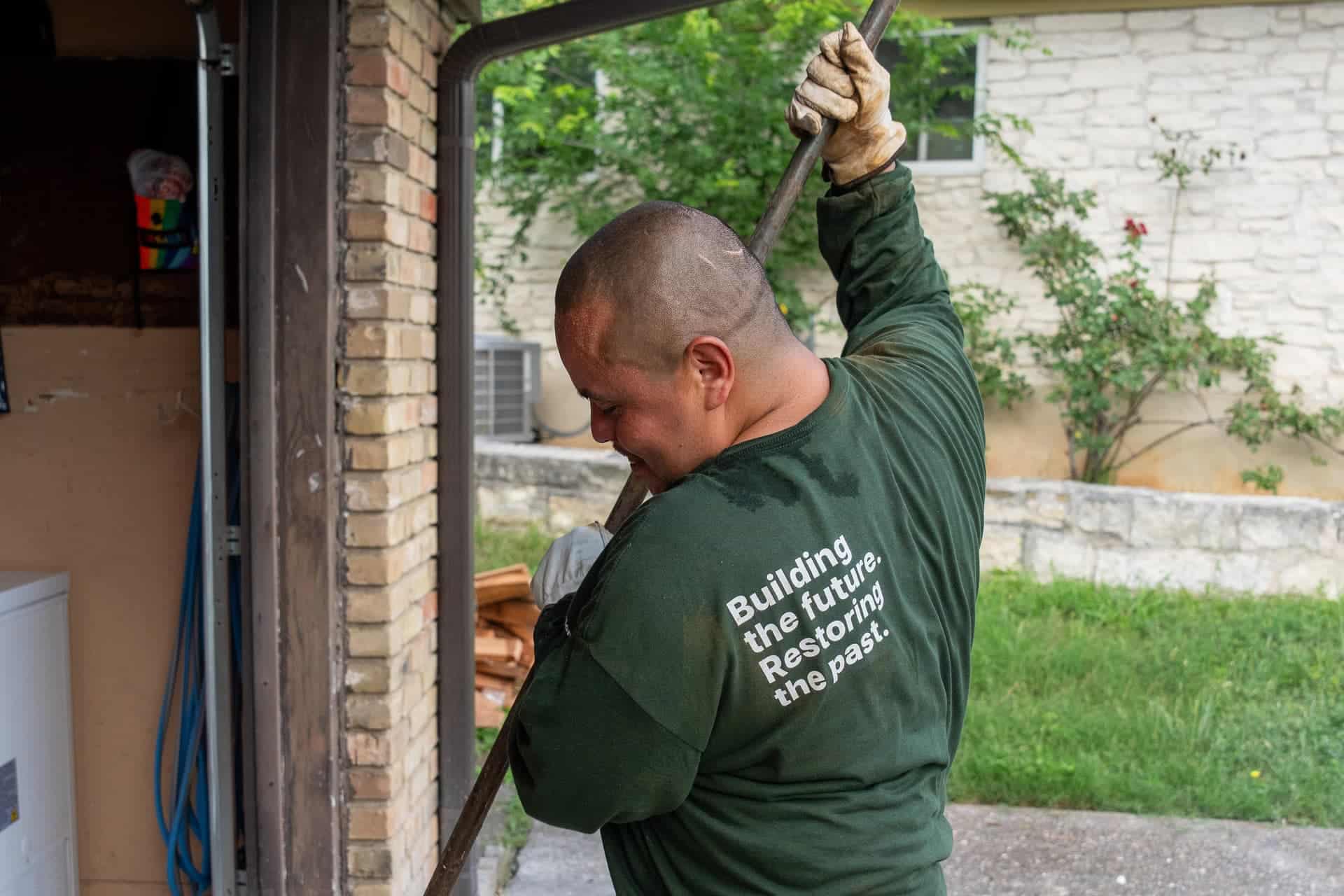 Quality Foundation Repair Austin team member working by hand at a doorway opening.