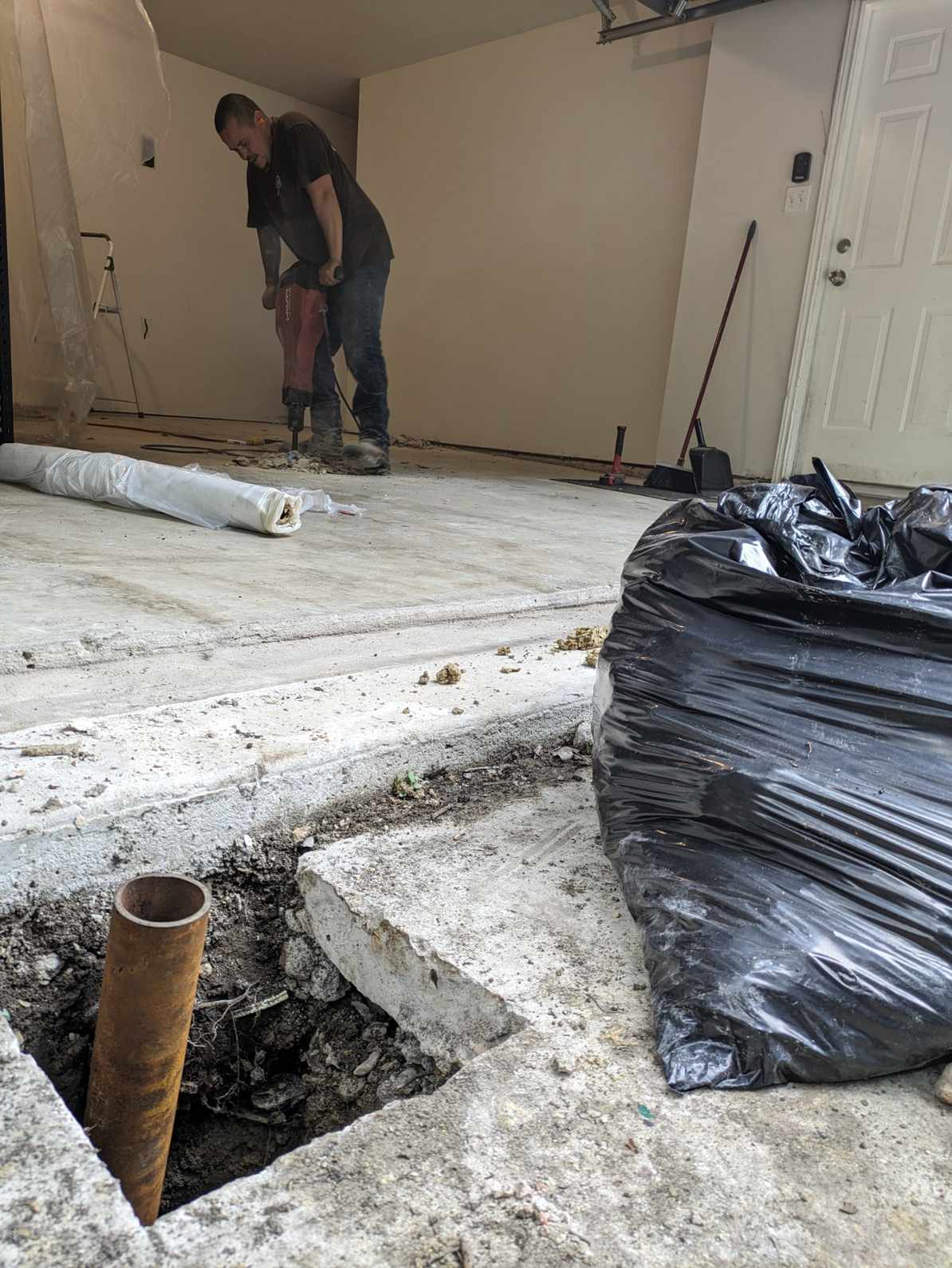 Quality Foundation Repair Austin breaking out an interior slab to reach the plumbing beneath.