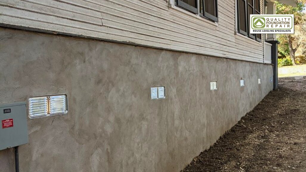 Quality Foundation Repair Austin showcasing a clean foundation wall with crawl space vents for moisture control.