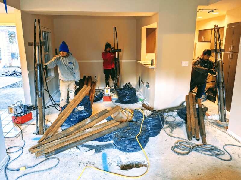 Quality Foundation Repair Austin team installing hydraulic push piers for residential foundation repair.