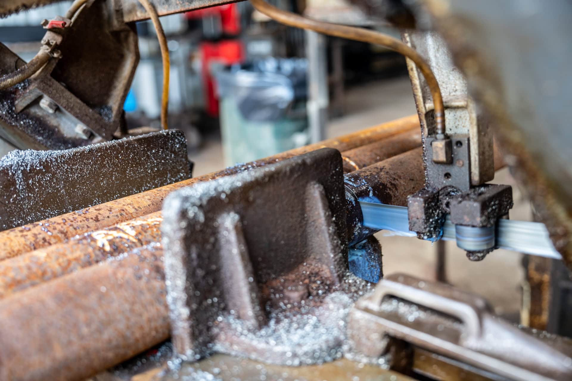 Quality Foundation Repair Austin fabricating steel components for deep foundation systems with a metal cutting band saw.