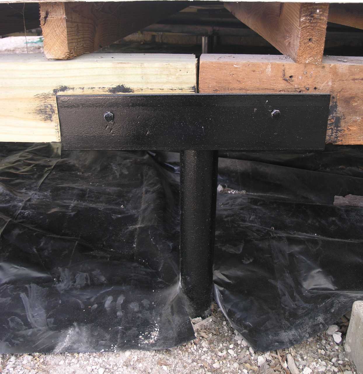Quality Foundation Repair Austin installing isolated pier and beam support in a crawl space with a new vapor barrier.