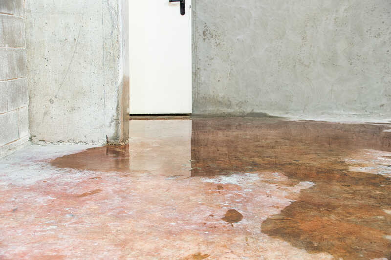 Quality Foundation Repair Austin documenting standing water on a concrete floor in a crawl space.