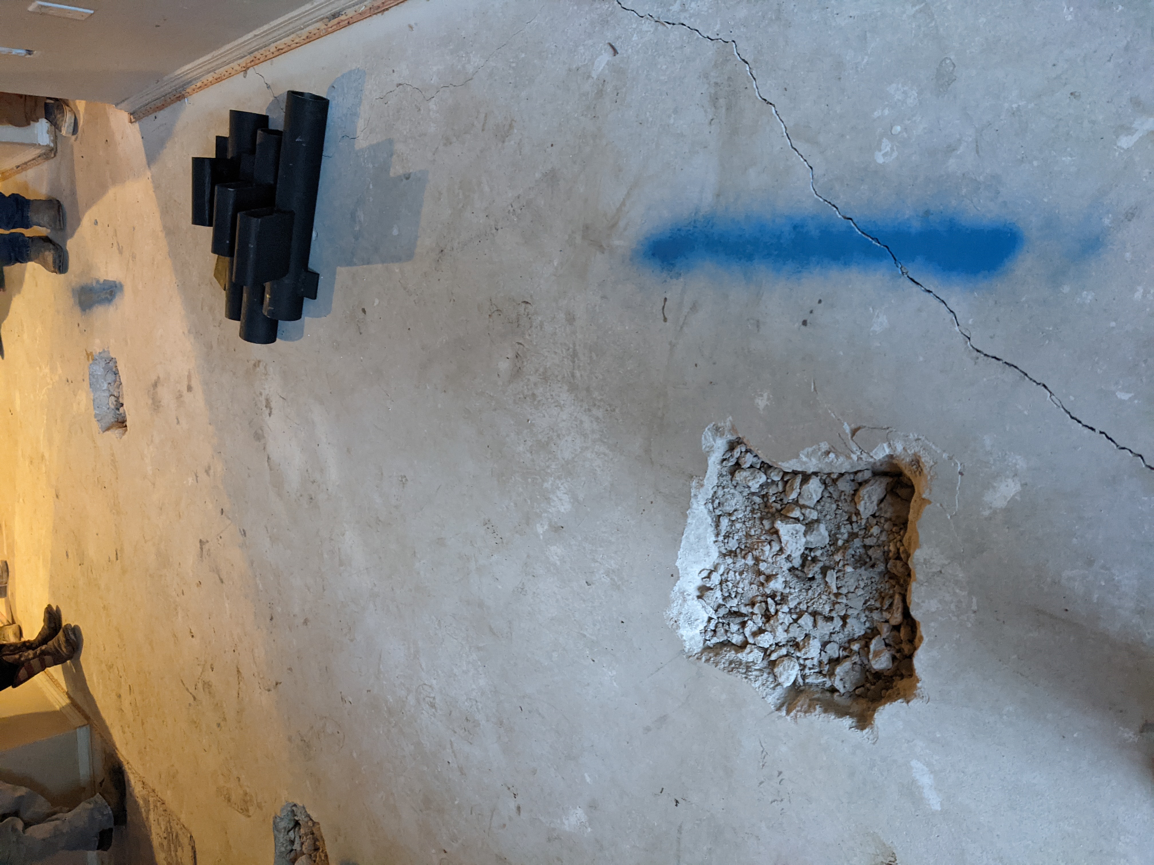 Quality Foundation Repair Austin installing steel push piers to repair a concrete slab foundation with floor cracks.