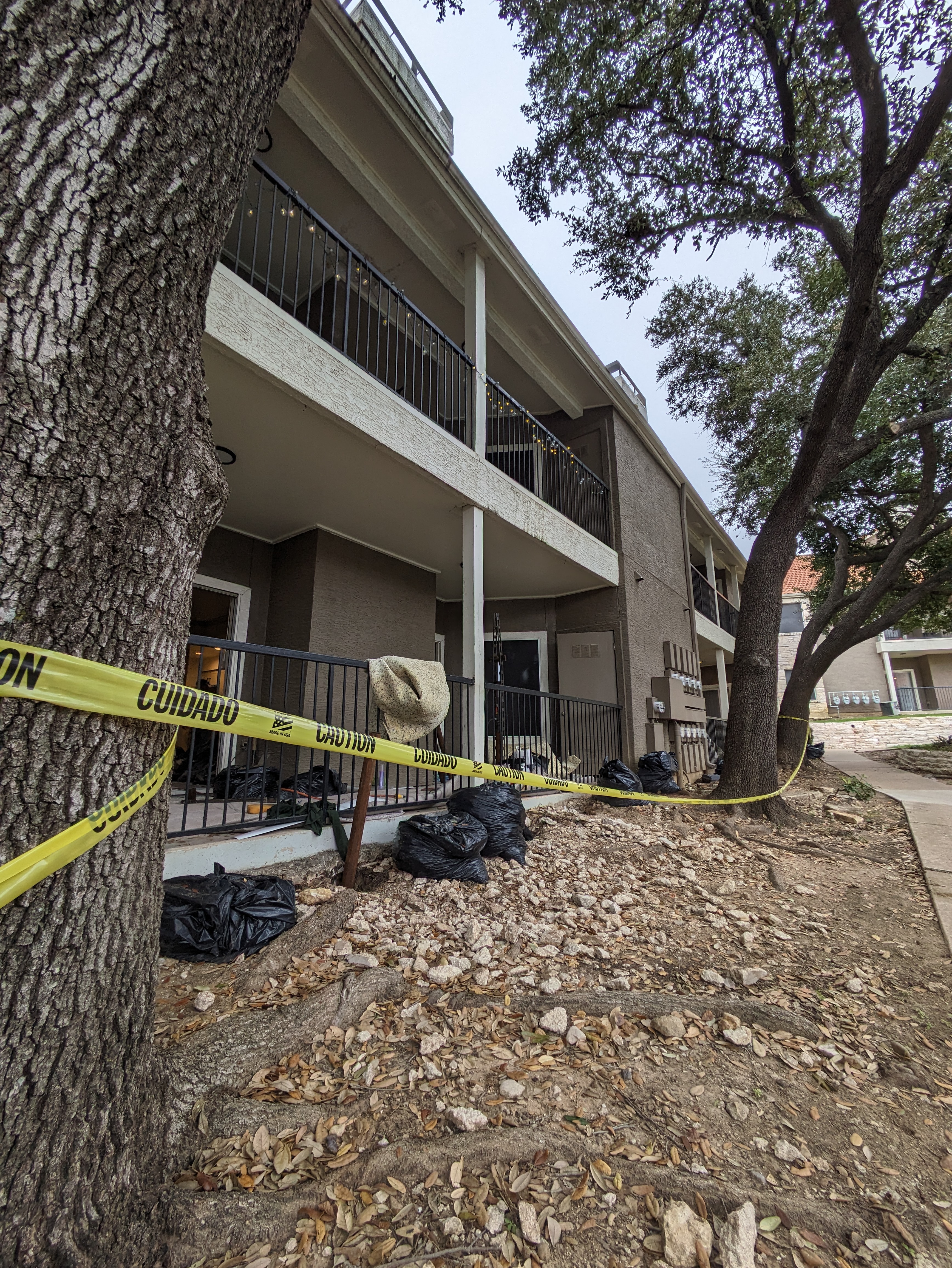Quality Foundation Repair Austin inspecting an apartment building's exterior for commercial foundation repair.