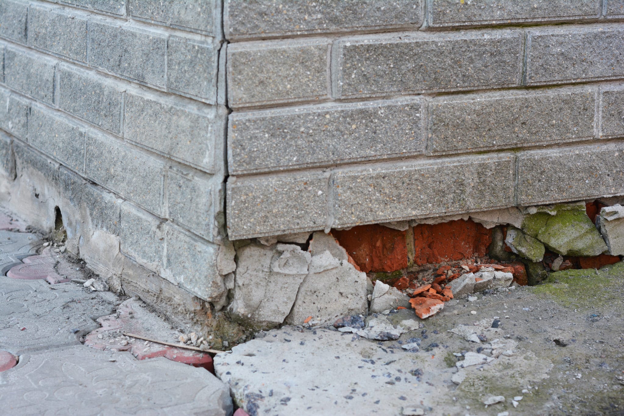 Inspecting severe cracked bricks and foundation settlement.