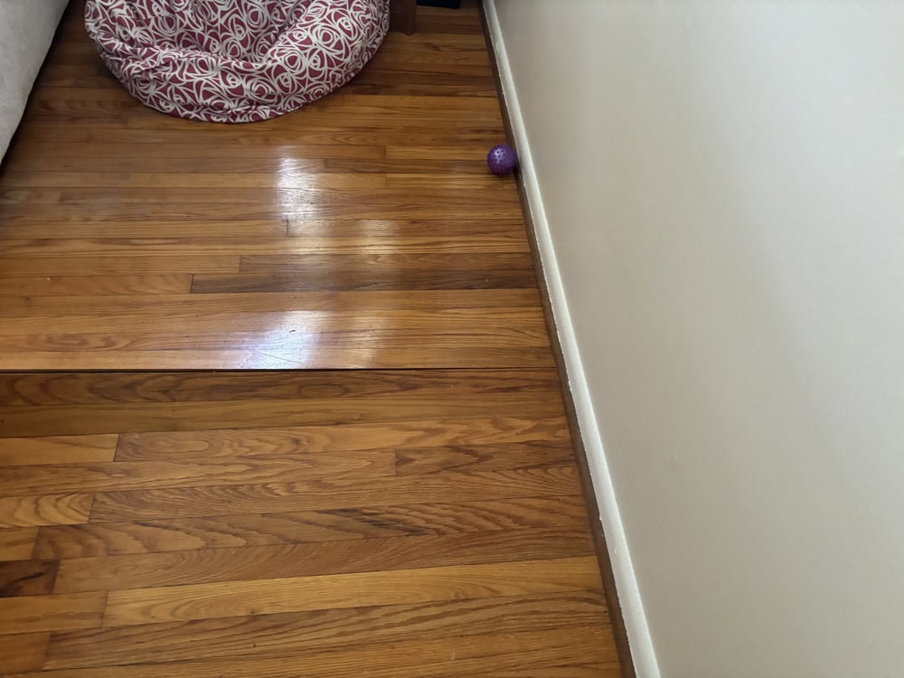Ground Up Foundation Repair, Waterproofing and Concrete Leveling inspecting sagging hardwood floors due to foundation settlem