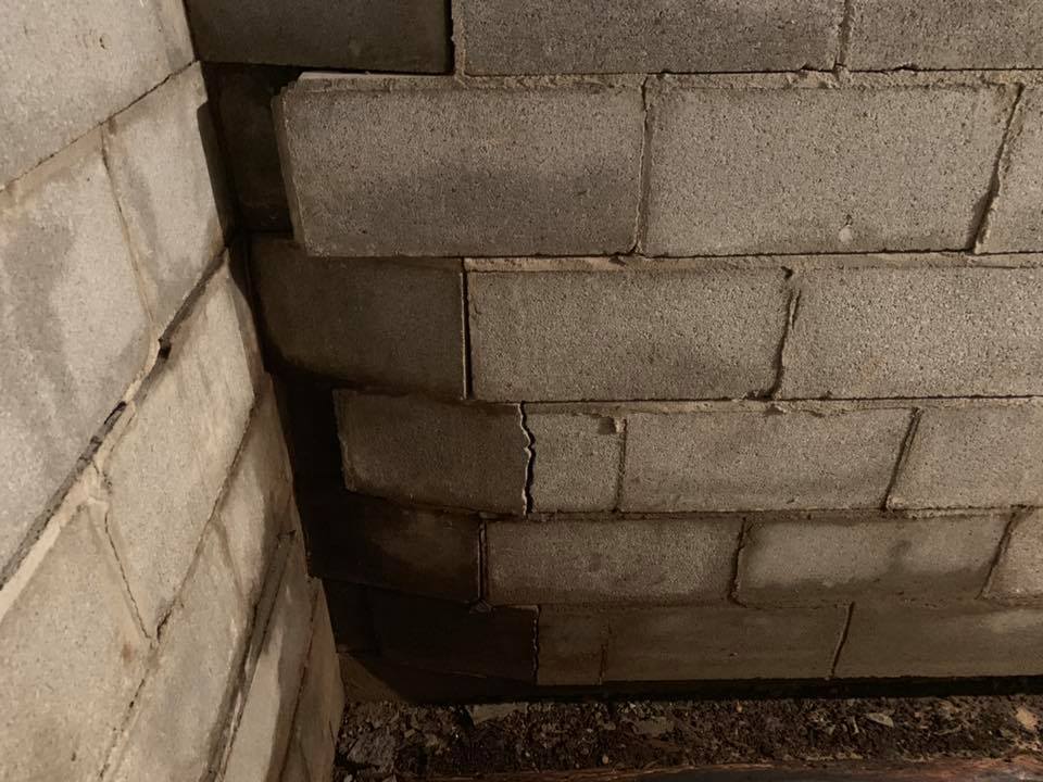 Ground Up Foundation Repair, Waterproofing and Concrete Leveling inspecting a severely bowing concrete block basement wall.