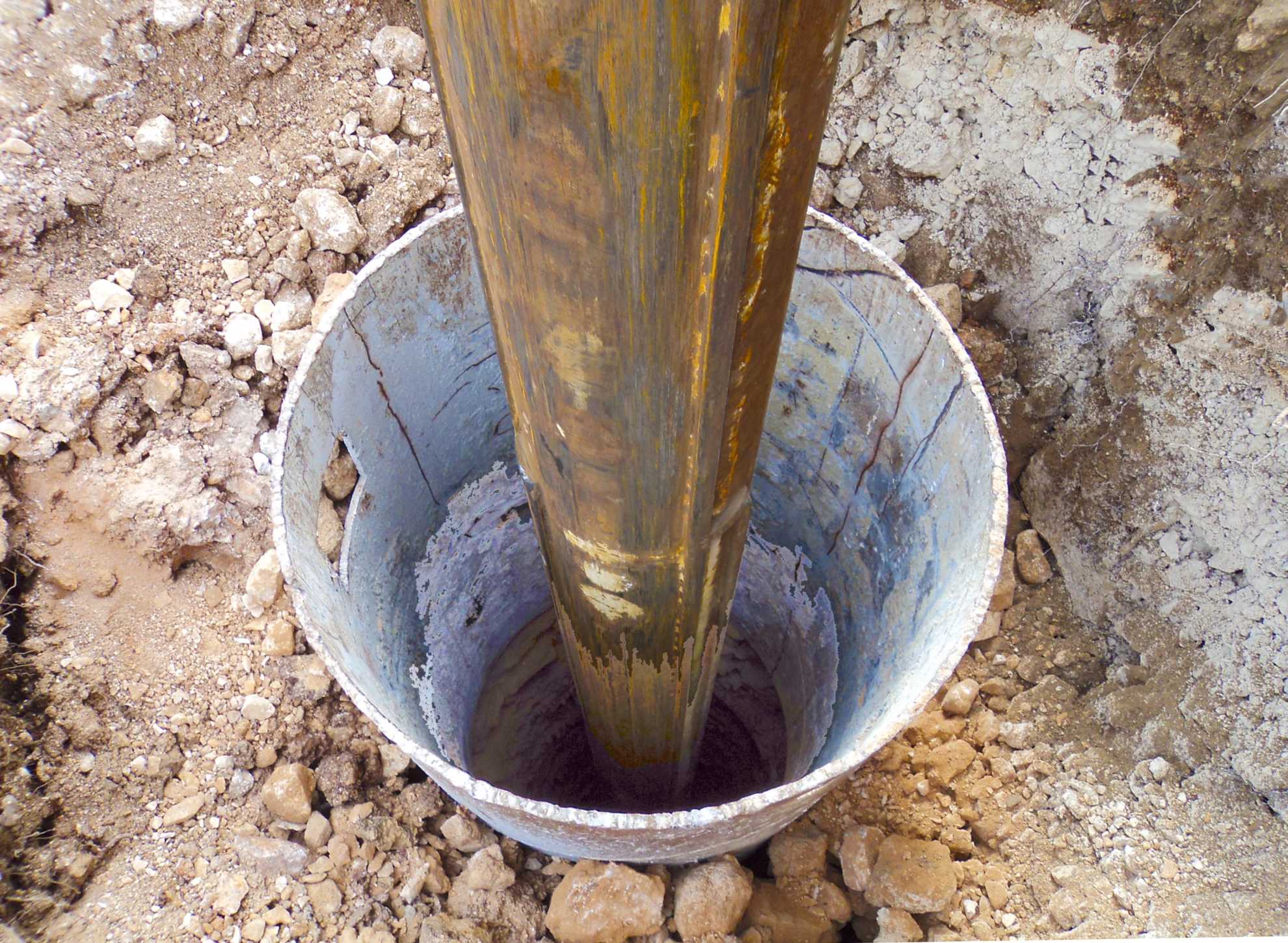Ground Up Foundation Repair, Waterproofing and Concrete Leveling installing a foundation pier for post and pier foundation re