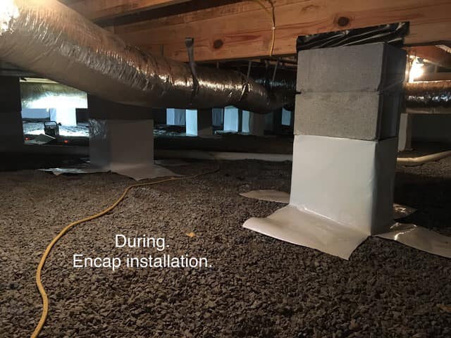 Ground Up Foundation Repair, Waterproofing and Concrete Leveling installing a vapor barrier around concrete piers in a crawl 