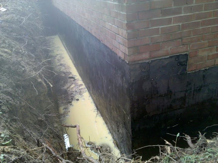 Ground Up Foundation Repair, Waterproofing and Concrete Leveling identifying standing water in an exterior foundation trench.