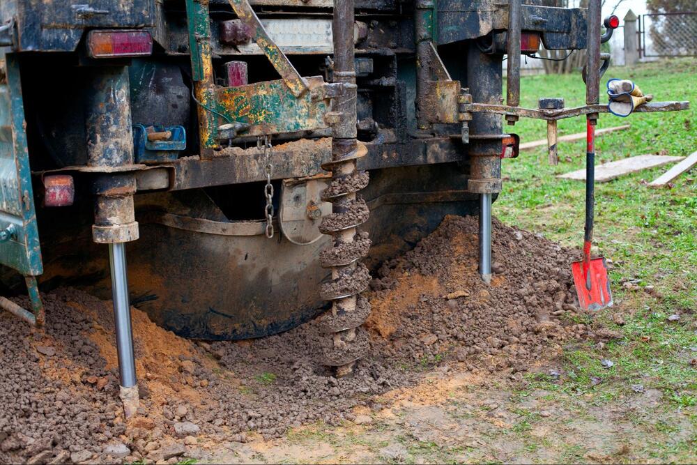 Ground Up Foundation Repair, Waterproofing and Concrete Leveling performing foundation repair with a heavy-duty drilling rig 