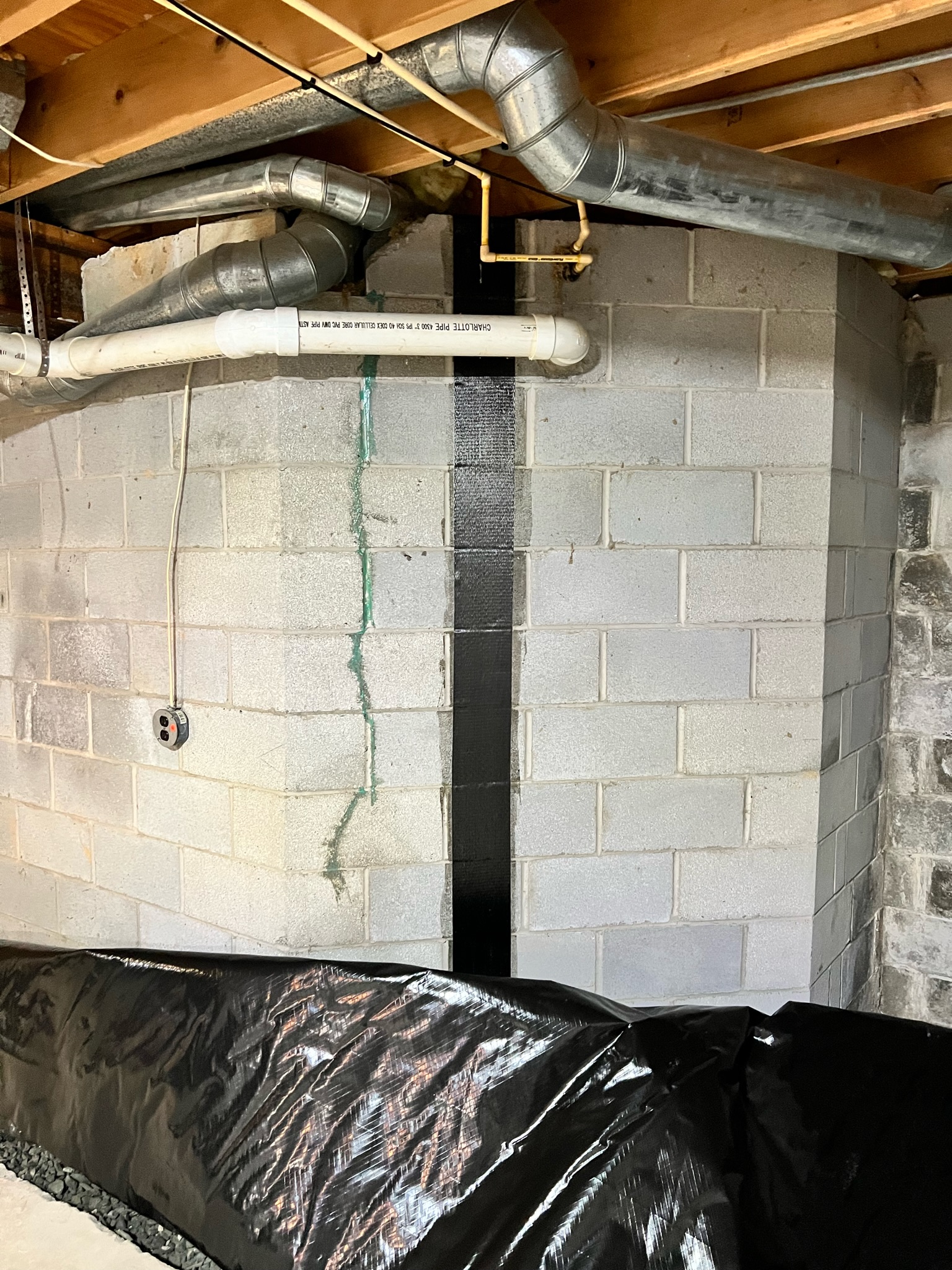 Carbon fiber crack repair on a foundation wall in a Maryland home near an affected cabinet run