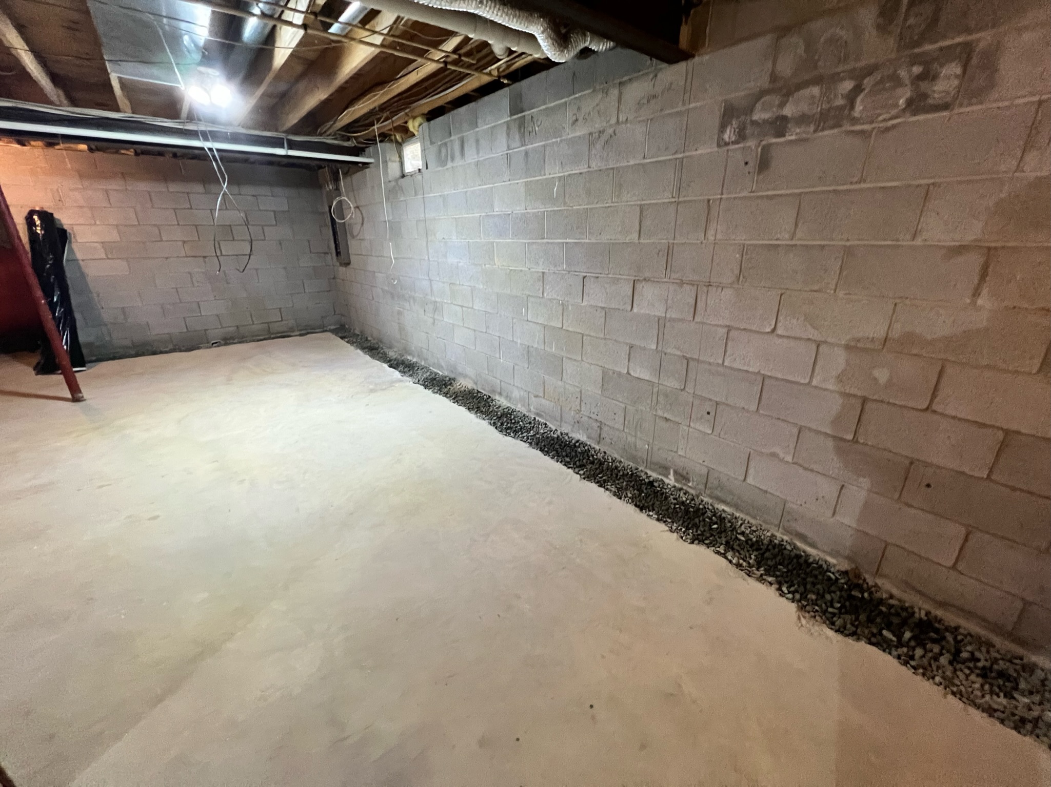 OBW installing an interior drainage system with gravel trench in a Maryland crawl space
