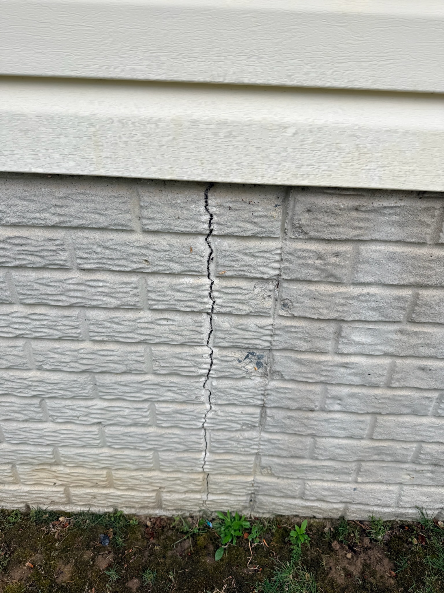 Vertical crack through exterior block foundation showing advanced deterioration in a Maryland home