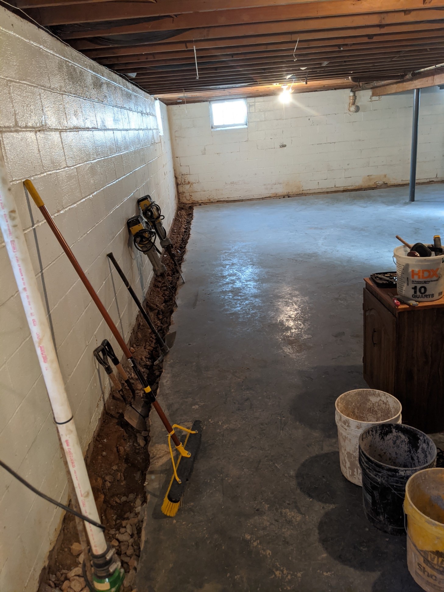 Oriole Basement Waterproofing installing an interior crawl space drainage system with trench and pipe