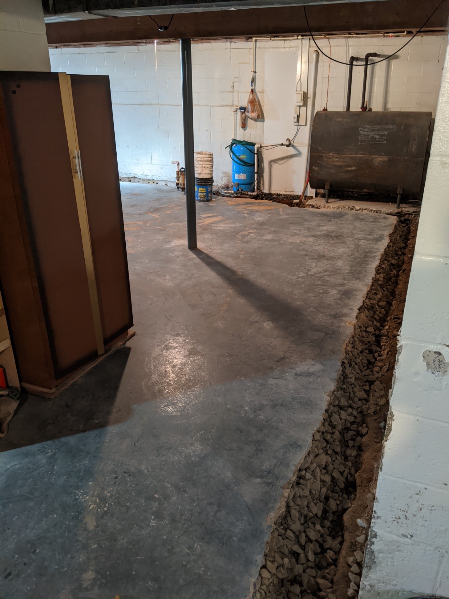 Interior perimeter drainage system tied into a sump pump in a Maryland basement