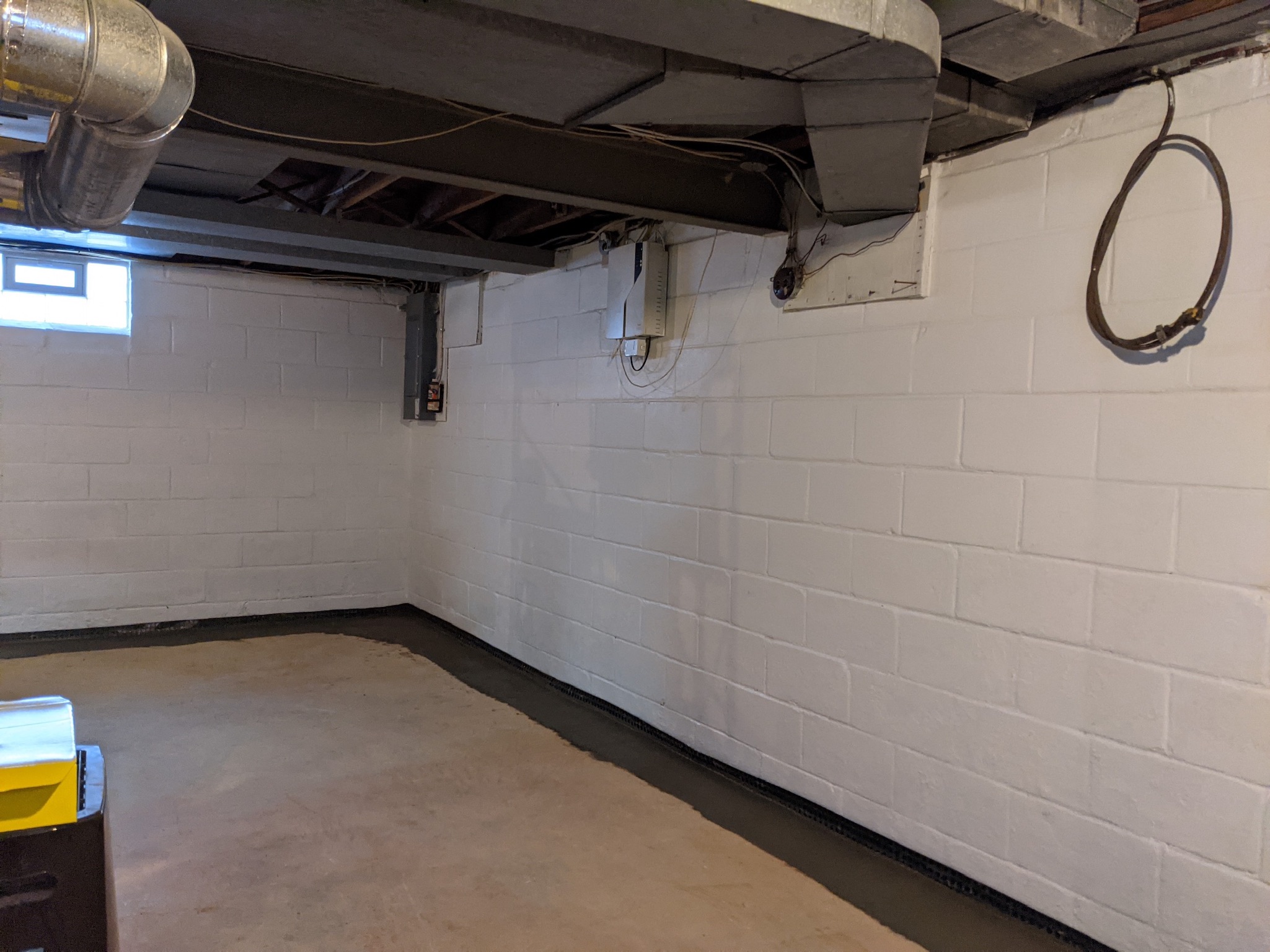 French drain installation with gravel bed in a Maryland basement
