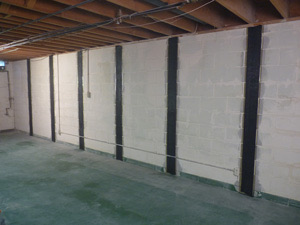 Carbon fiber straps bonded along a basement foundation wall in a Maryland home