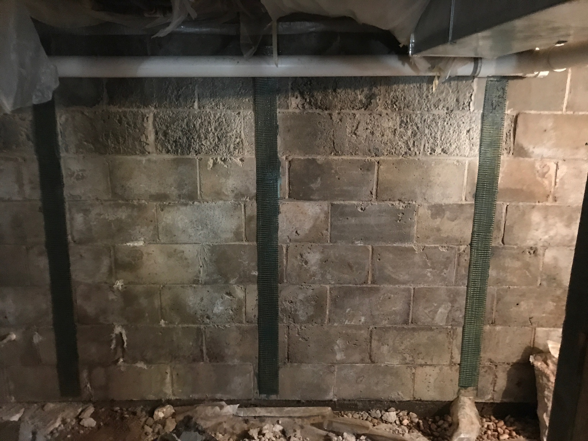 Carbon fiber straps bonded to a bowing block foundation wall