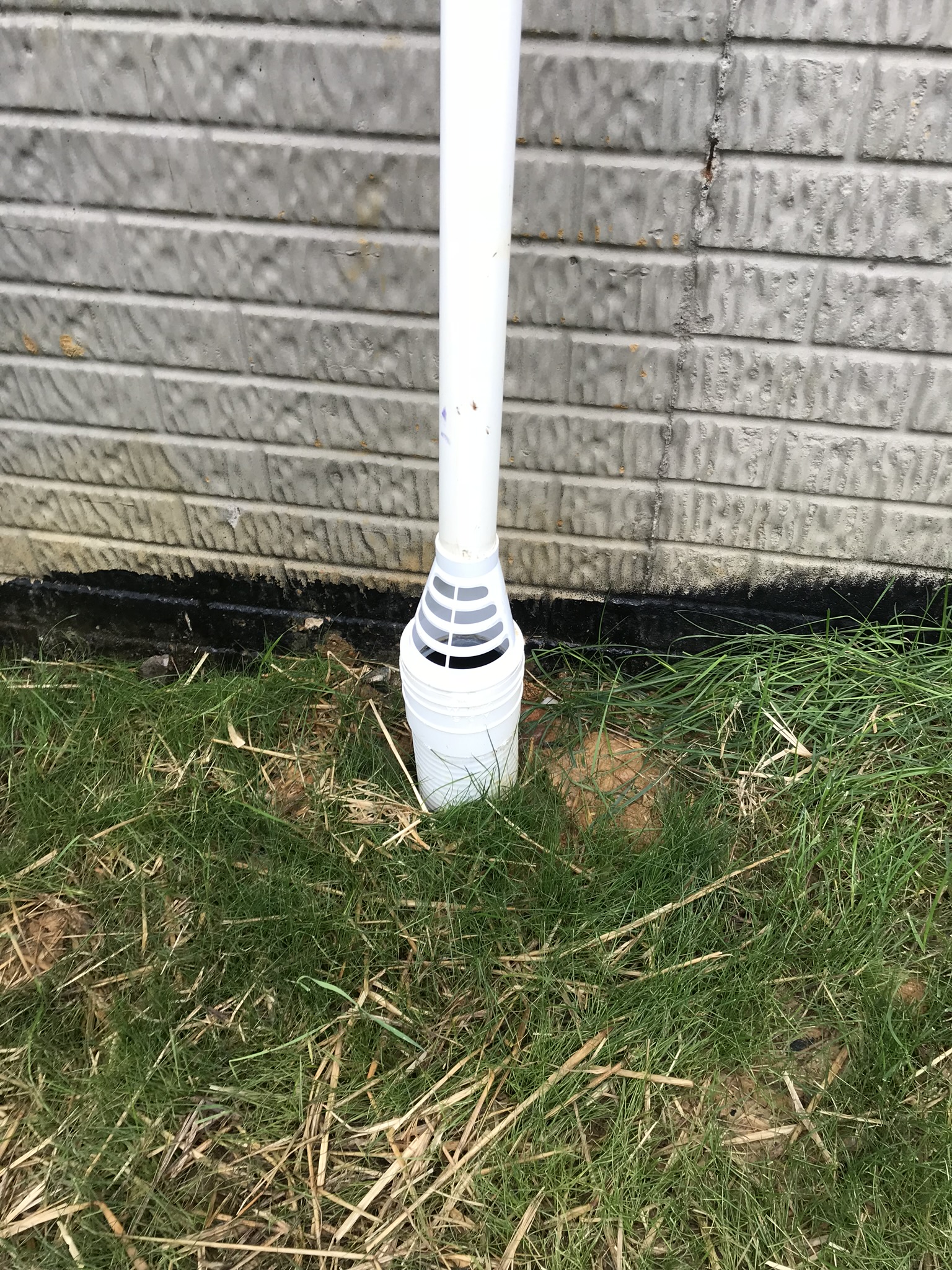Discharge line carrying water away from the foundation