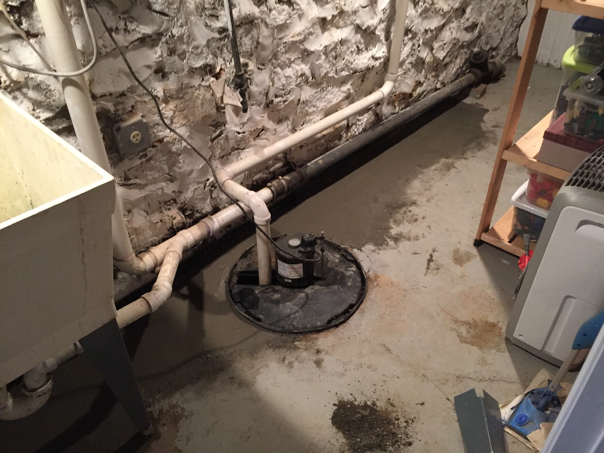 Sump pump with drainage pipes during backup pump installation