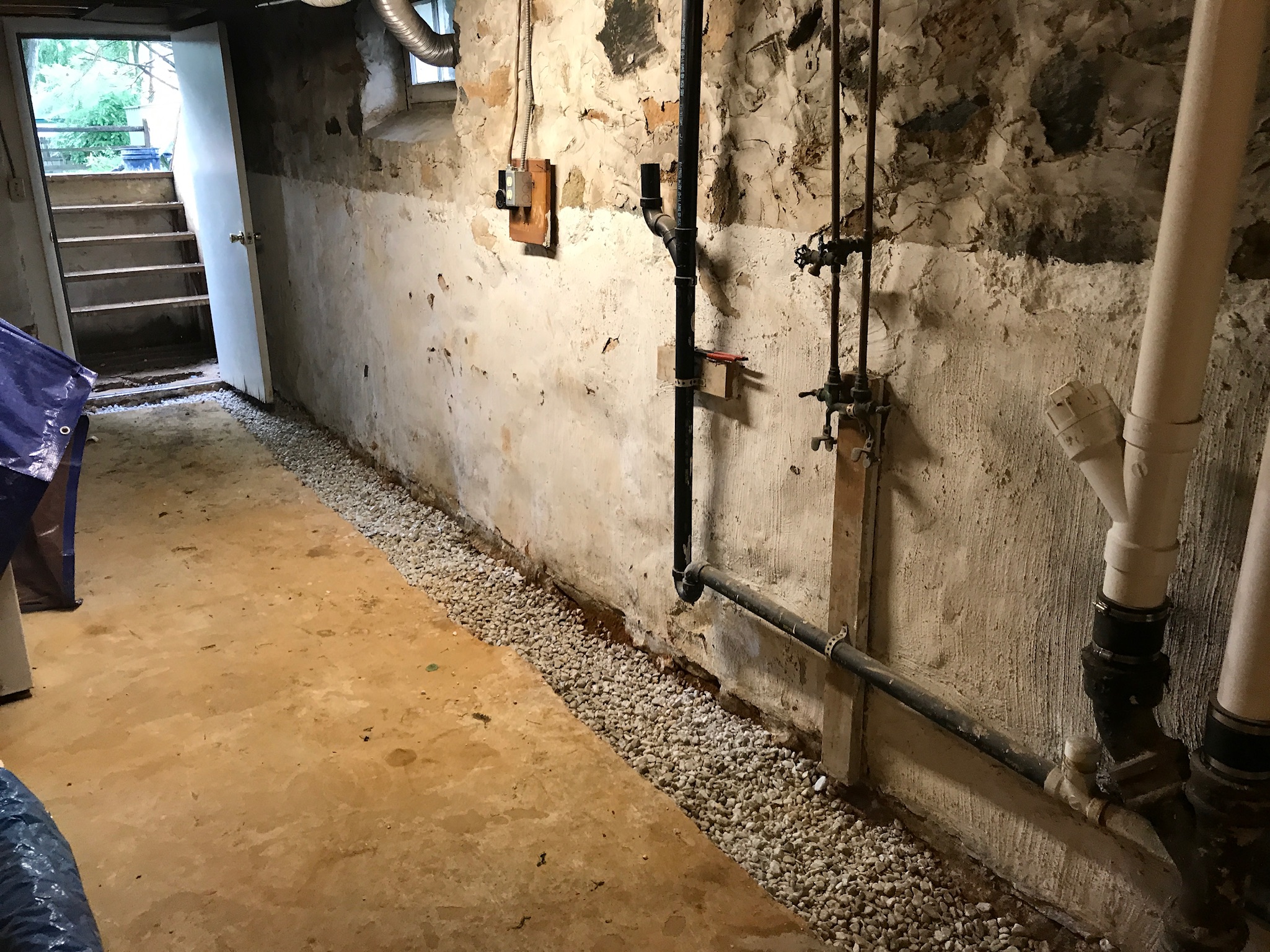Water seepage, mold growth, and peeling paint on a Maryland basement wall