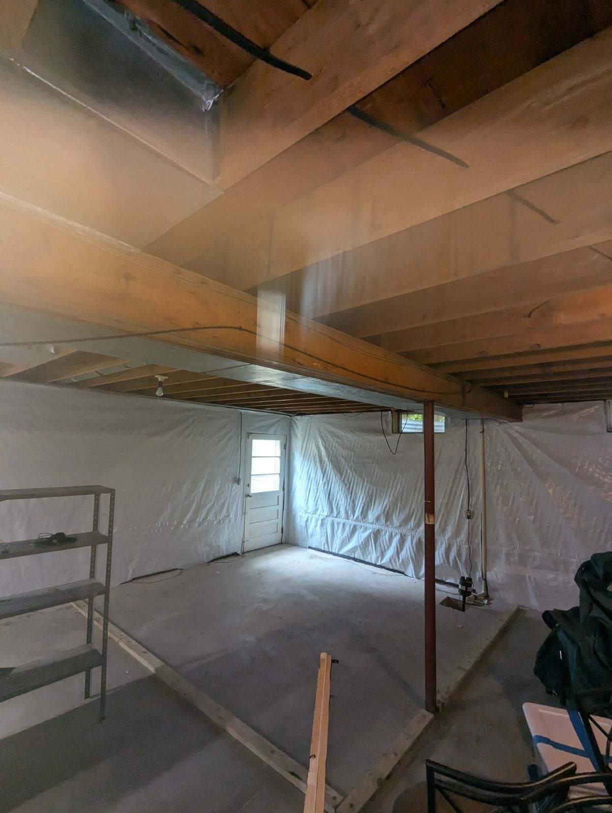 Encapsulated crawl space with liner covering the walls and floor
