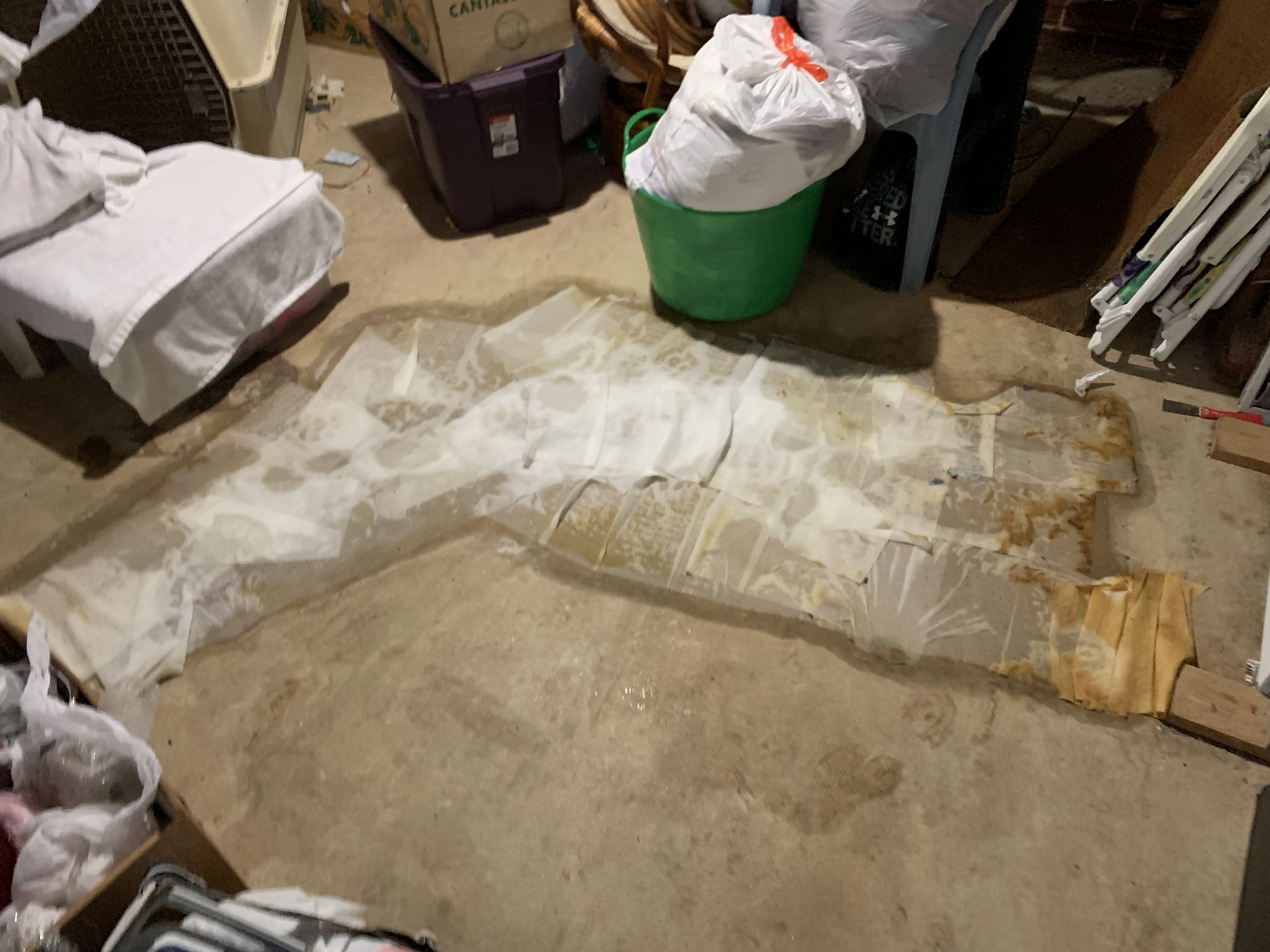 Wet concrete basement floor with water intrusion at cove joint, staining and deterioration