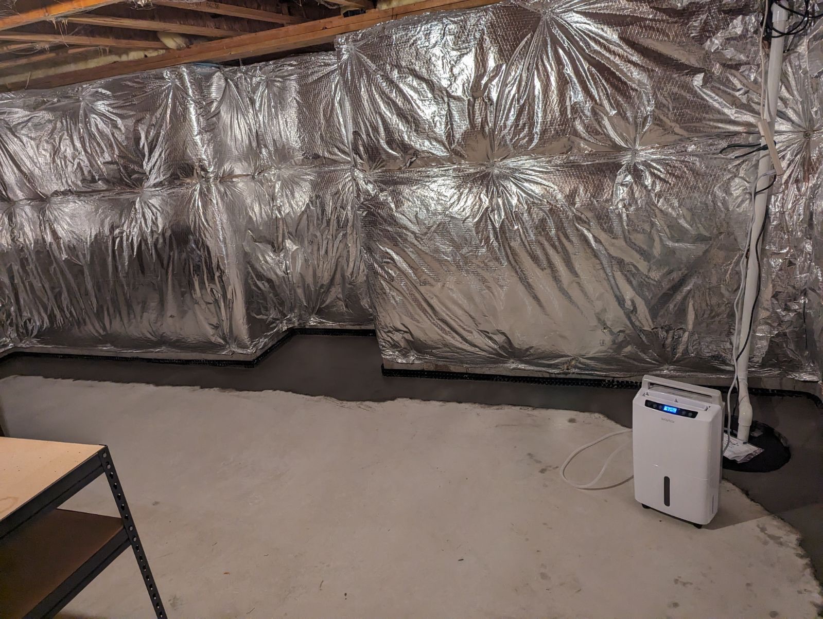 Oriole Basement Waterproofing installing comprehensive basement vapor barrier, dehumidifier, and sump pump system.