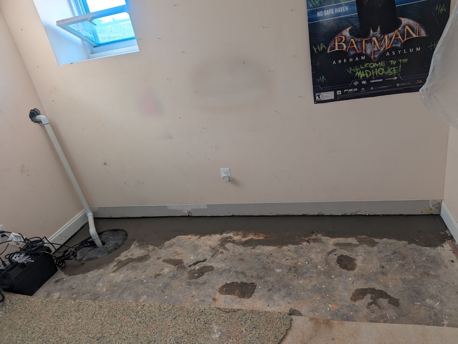 Flooded basement with standing water and signs of water damage