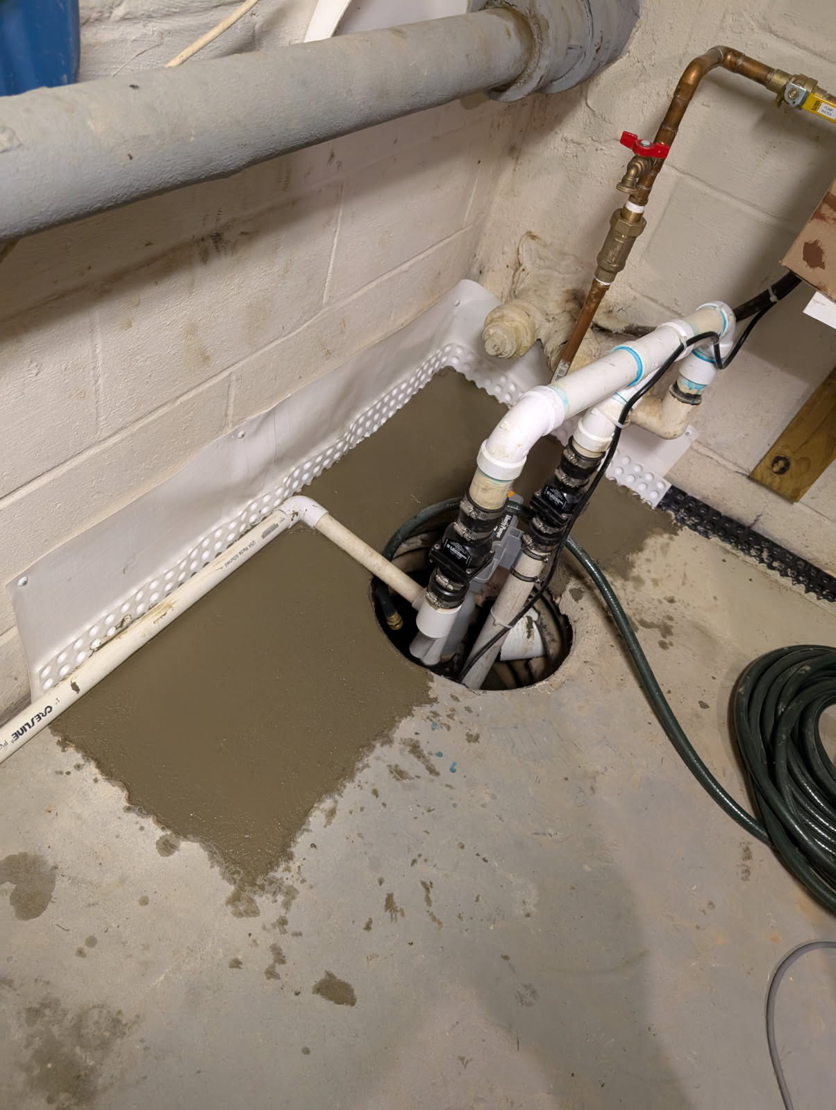 Interior drainage system with fresh concrete restoration in a basement
