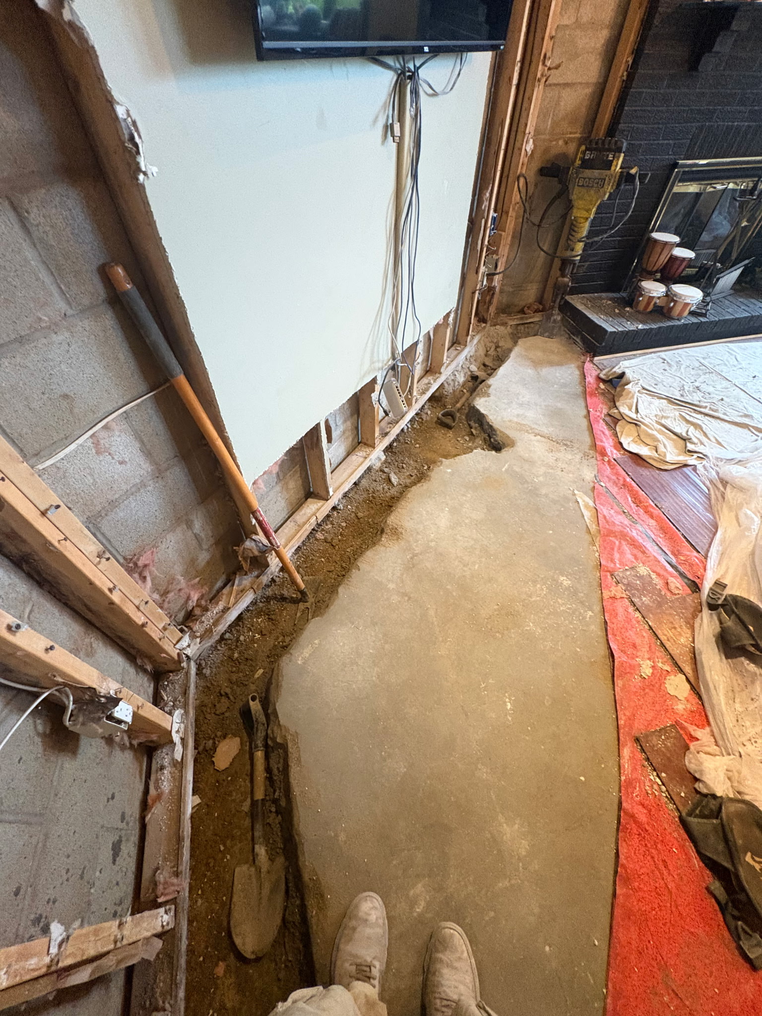 OBW crew cutting perimeter trench for interior drainage system in Maryland basement