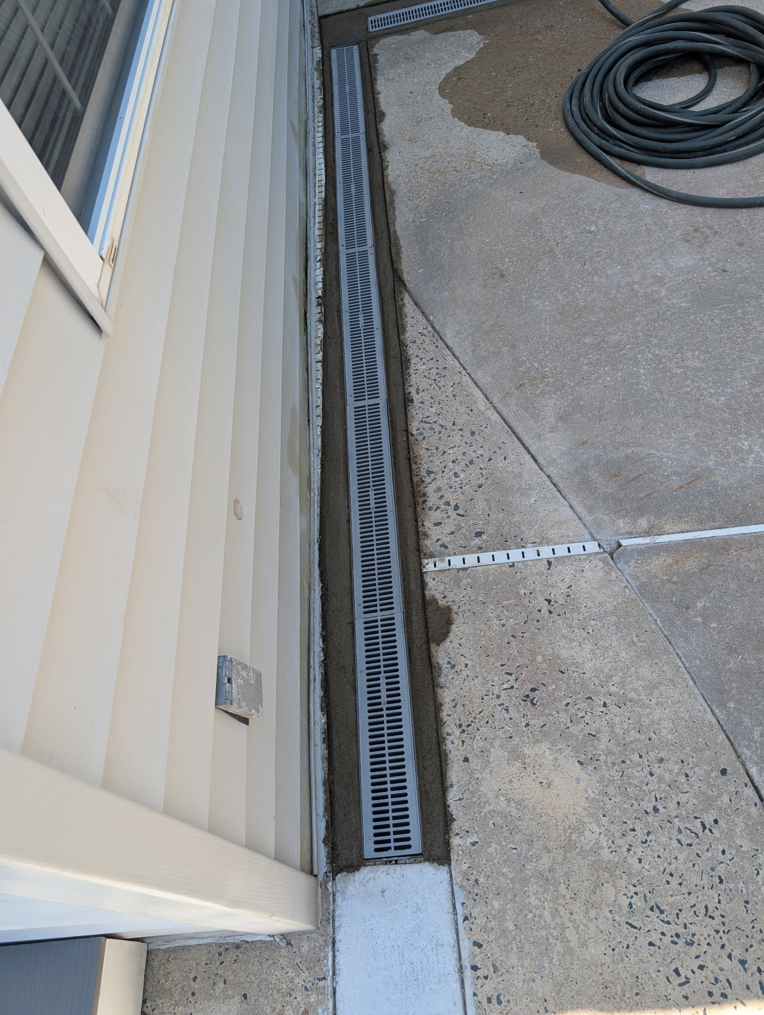 Surface drainage system installed to stop yard pooling near a Maryland foundation