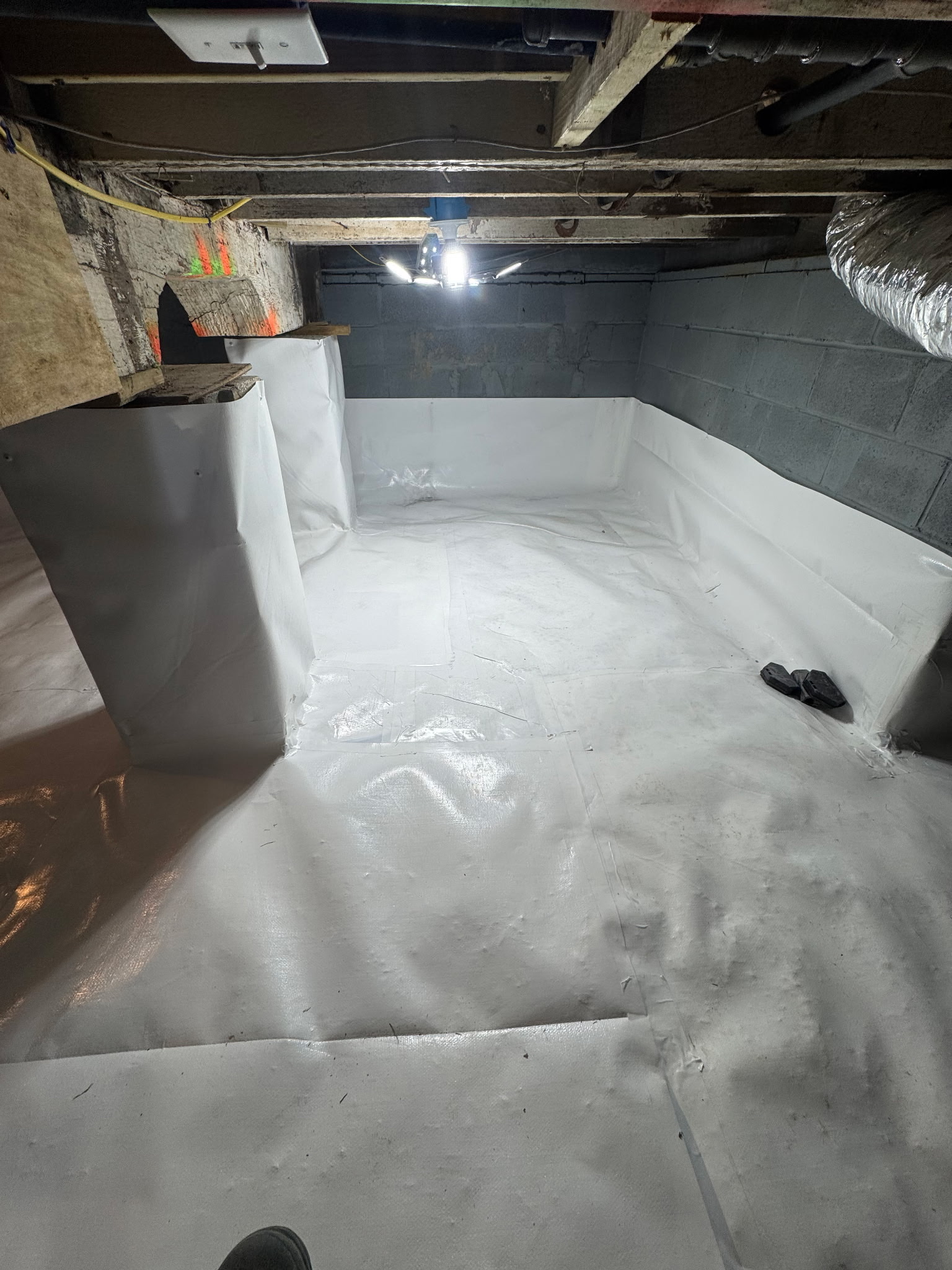 Oriole Basement Waterproofing completes crawl space encapsulation with a bright white vapor barrier.