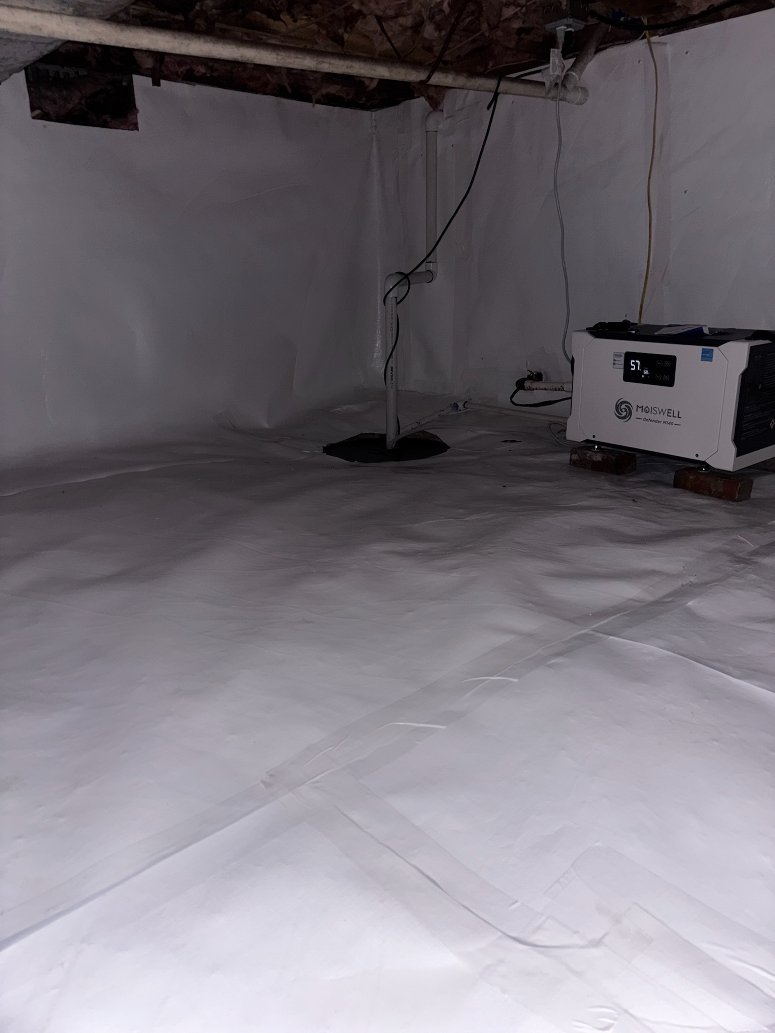 Oriole Basement Waterproofing installing a full crawl space encapsulation system with vapor barrier, sump pump, and dehumidifier.