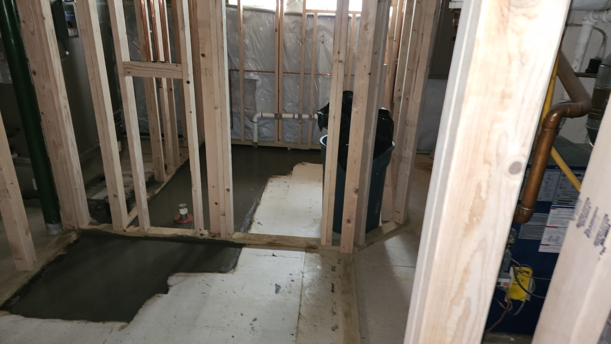 Vapor barrier, drainage system, and concrete pour completed in a Maryland crawl space to eliminate moisture