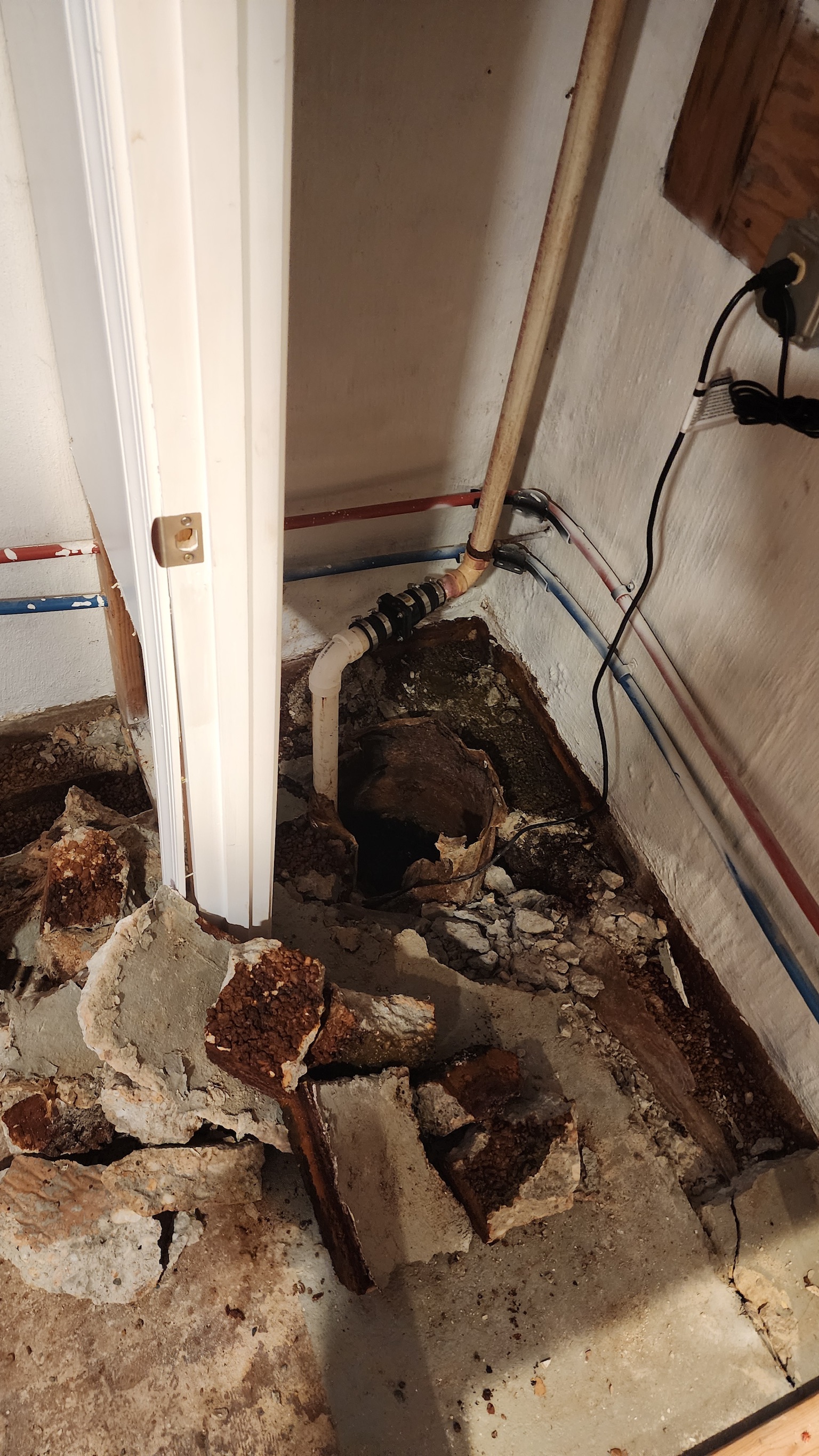 Old rusted and broken sump pump showing signs of failure in a Maryland basement