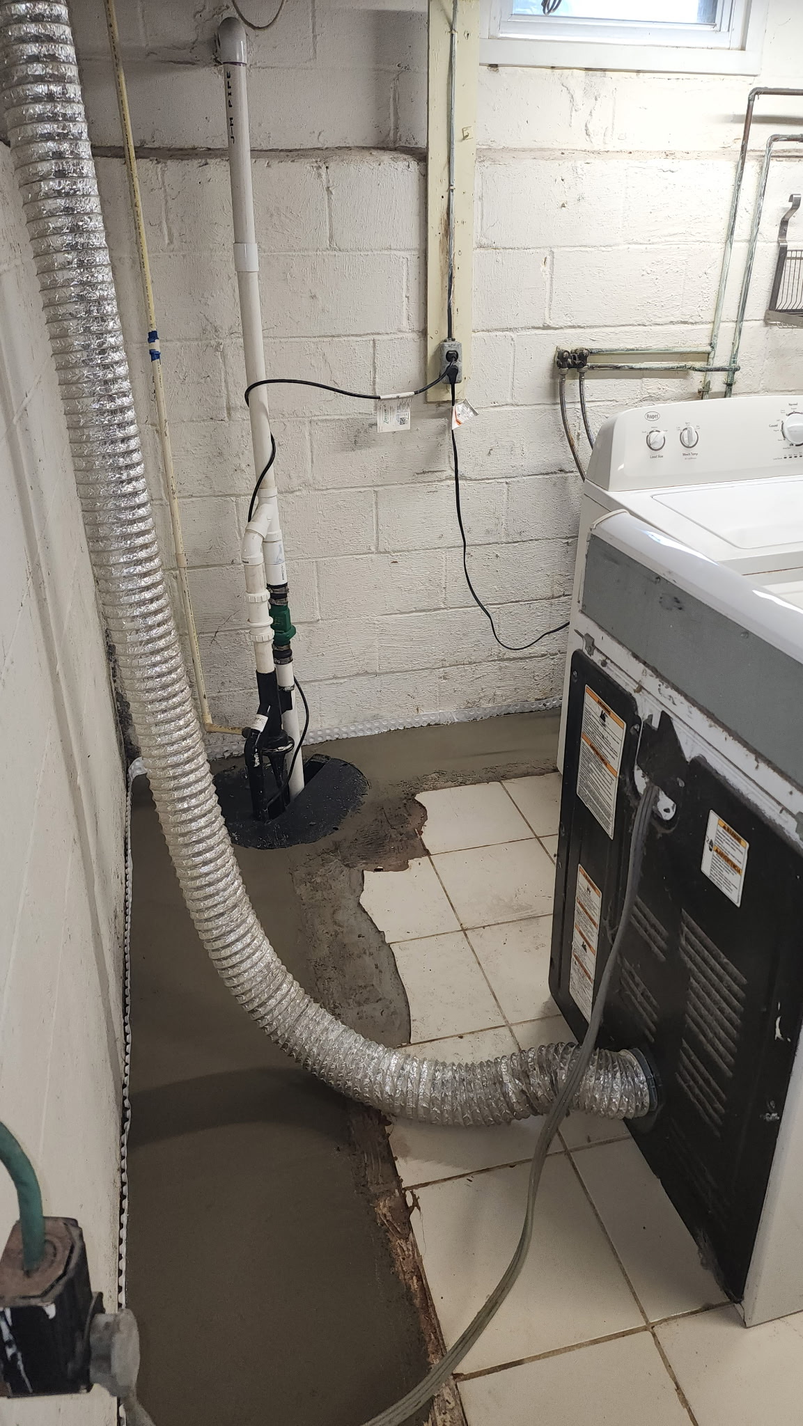 New sump basin and drain tile connection in a basement