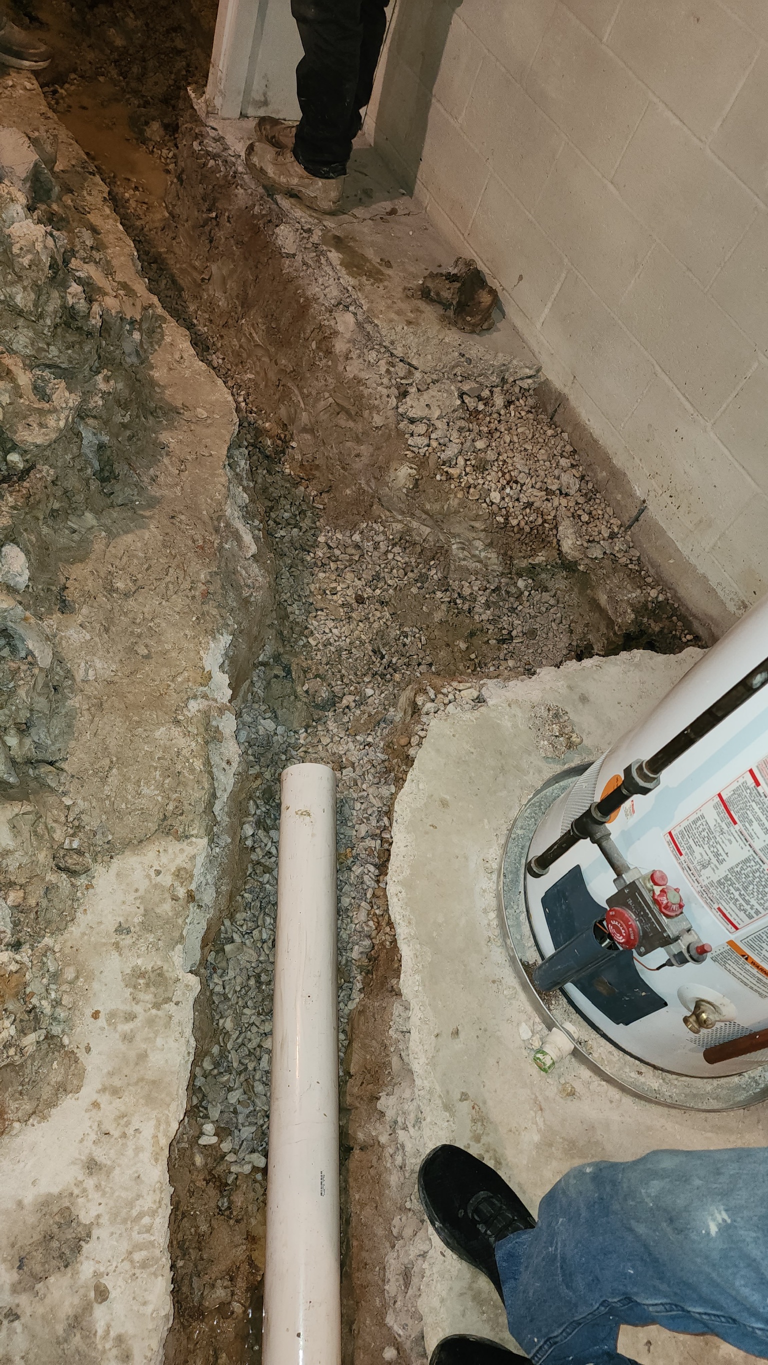 PVC drain tile and washed stone in an interior footer trench