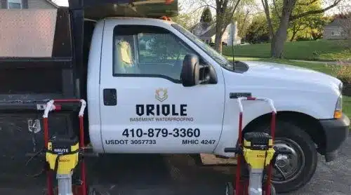 Oriole Basement Waterproofing service truck and excavation equipment on a Maryland job site