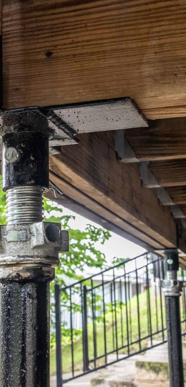 Quality Foundation Repair Austin Adjust-A-Pier stabilizing a crawl space beneath a deck.