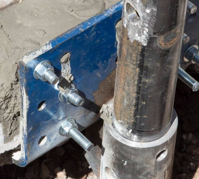 Quality Foundation Repair Austin installing a steel push pier foundation bracket and steel pier into the concrete foundation.