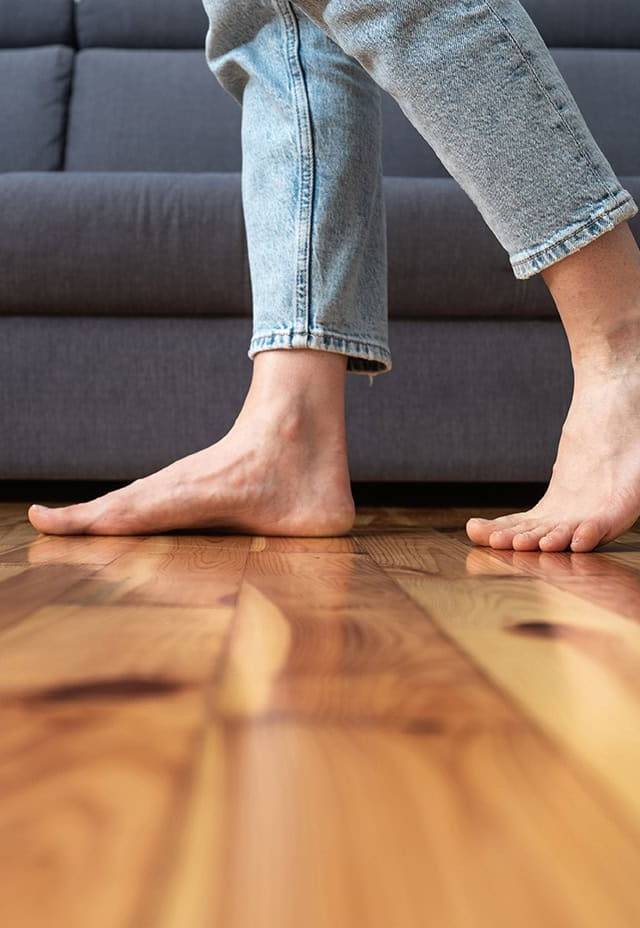 Quality Foundation Repair Austin showing signs of bouncing floors with bare feet on a wood floor.