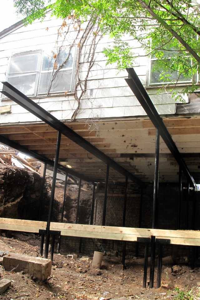 Quality Foundation Repair Austin installing structural steel beams and support jacks for crawl space stabilization.
